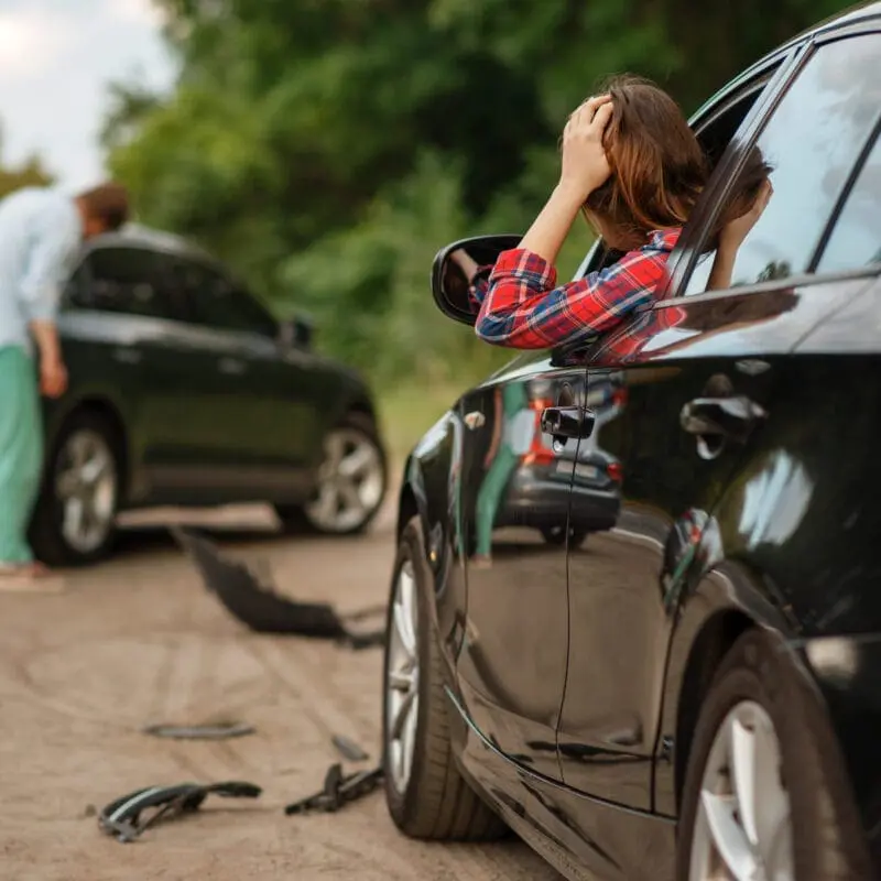 Male and female drivers after car accident on road. Automobile crash. Broken automobile or damaged vehicle, auto collision on highway. Steps after a car accident
