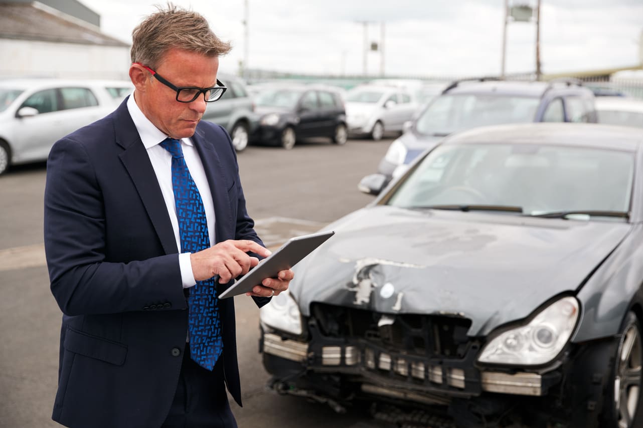insurance adjuster inspecting a leased car after accident