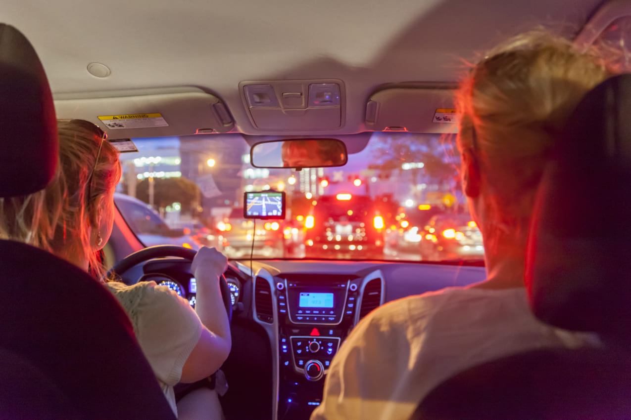 rideshare driver driving with passengers at night