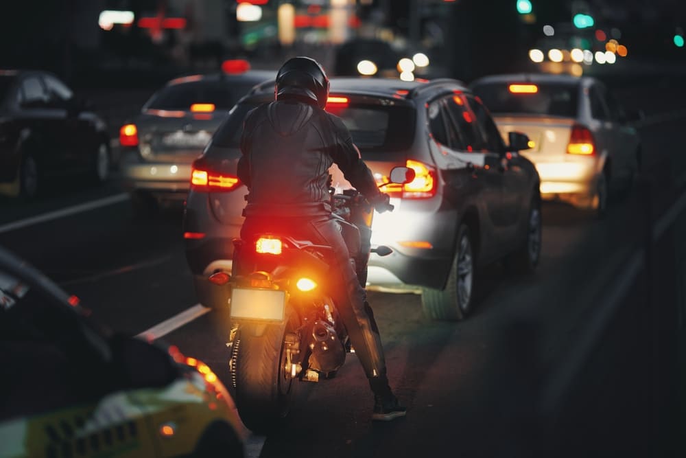 motorcycle in traffic at night